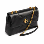 Tory Burch Kira in black calfskin with a gold double-T adjustable chain shoulder strap offering multiple carrying options for women