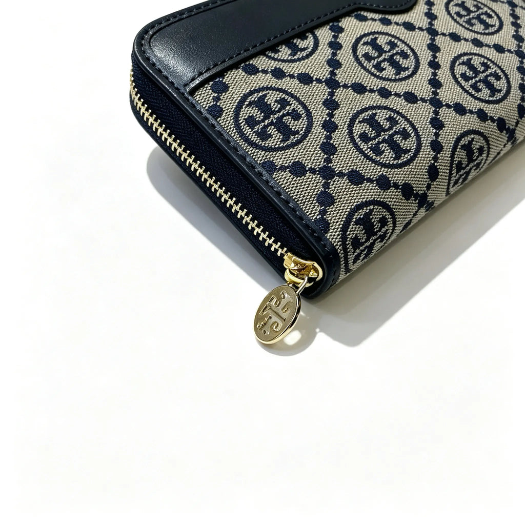 Tory Burch T Monogram wallet in navy and beige Monogram canvas, long with multiple card slots and a zipper