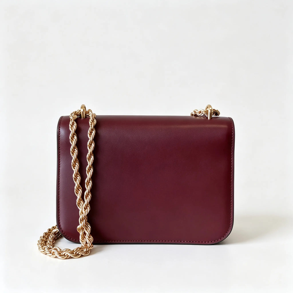 Tory Burch Eleanor burgundy with a gold double-T adjustable twist chain shoulder strap offering multiple carrying options for women