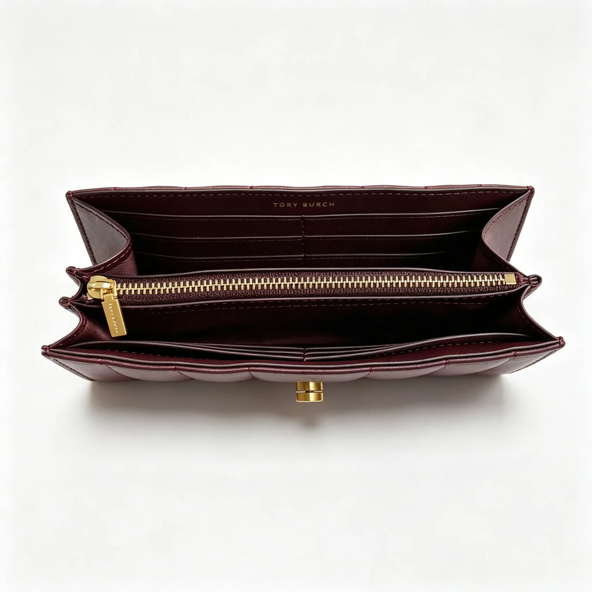 Tory Burch Kira burgundy quilted Nappa leather clutch with multiple card slots and a zippered coin purse
