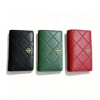 Tory Burch Fleming black quilted leather clutch with multiple card slots and a zippered coin pocket