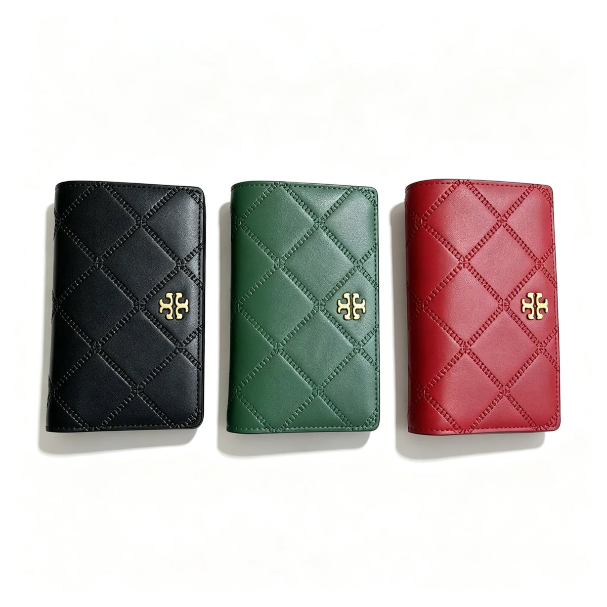 Tory Burch Fleming black quilted leather clutch with multiple card slots and a zippered coin pocket