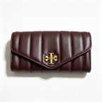 Tory Burch Kira burgundy quilted Nappa leather clutch with multiple card slots and a zippered coin purse
