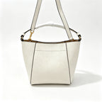 Tory Burch McGraw | Off-white pebbled leather with an adjustable shoulder strap and top handle  offering multiple carrying options  A women's designer handbag  perfect for work and weekend getaways