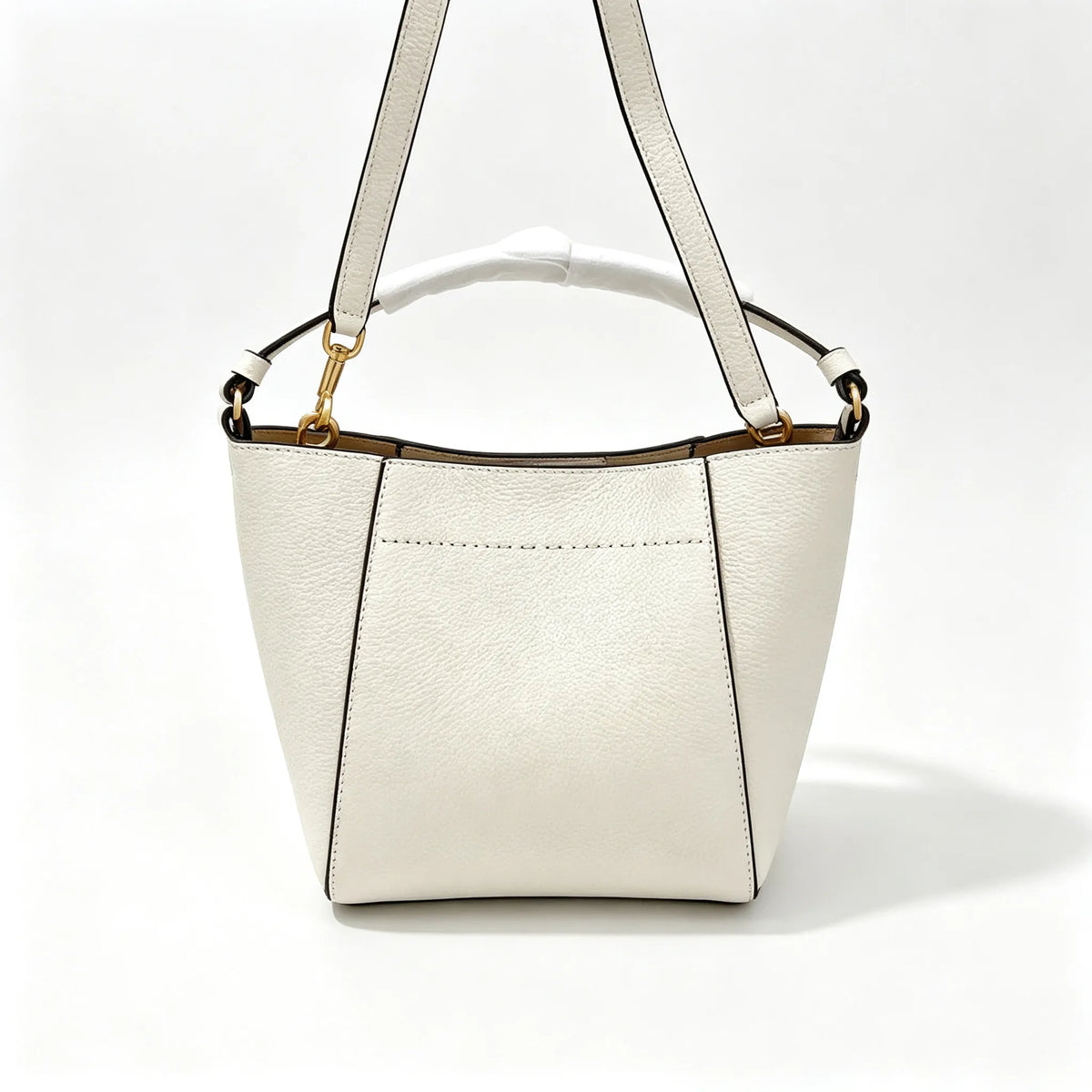 Tory Burch McGraw | Off-white pebbled leather with an adjustable shoulder strap and top handle  offering multiple carrying options  A women's designer handbag  perfect for work and weekend getaways