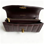 Tory Burch Kira burgundy quilted Nappa leather clutch with multiple card slots and a zippered coin purse