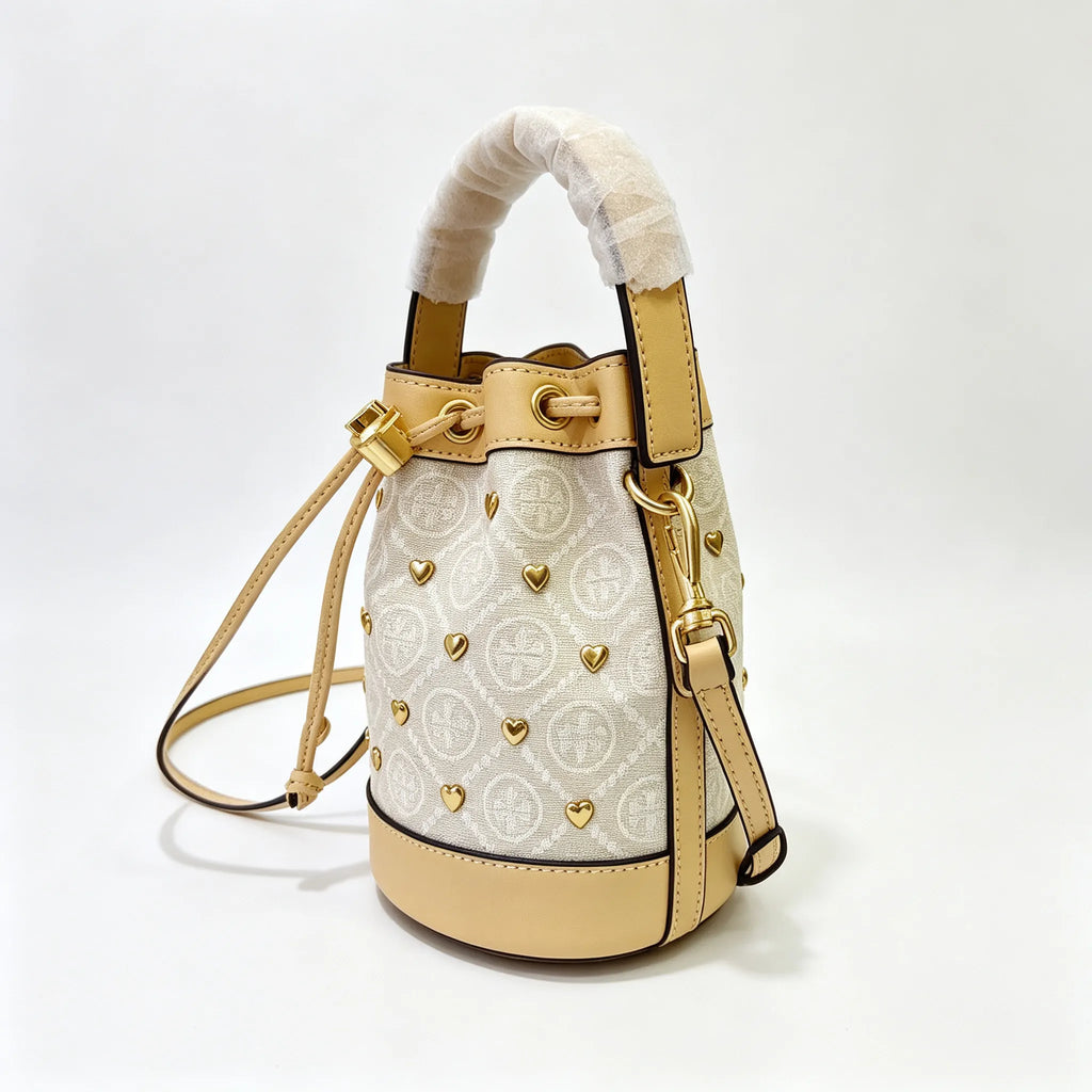 Tory Burch T Monogram ivory and beige Monogram canvas adorned with gold heart studs drawstring closure and detachable shoulder strap women's designer handbag