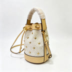 Tory Burch T Monogram ivory and beige Monogram canvas adorned with gold heart studs drawstring closure and detachable shoulder strap women's designer handbag