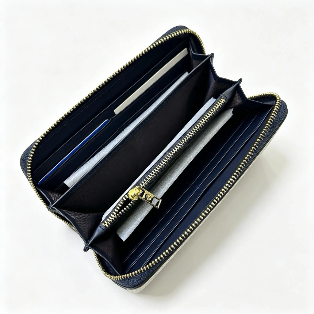 Tory Burch T Monogram wallet in navy and beige Monogram canvas, long with multiple card slots and a zipper