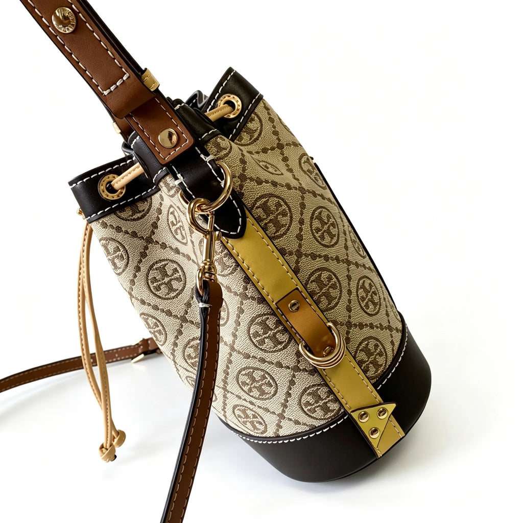 Tory Burch T Monogram | Off-white base with hazelnut brown monogram jacquard pattern and dark brown leather trim  drawstring closure versatile handbag suitable for commuting and travel