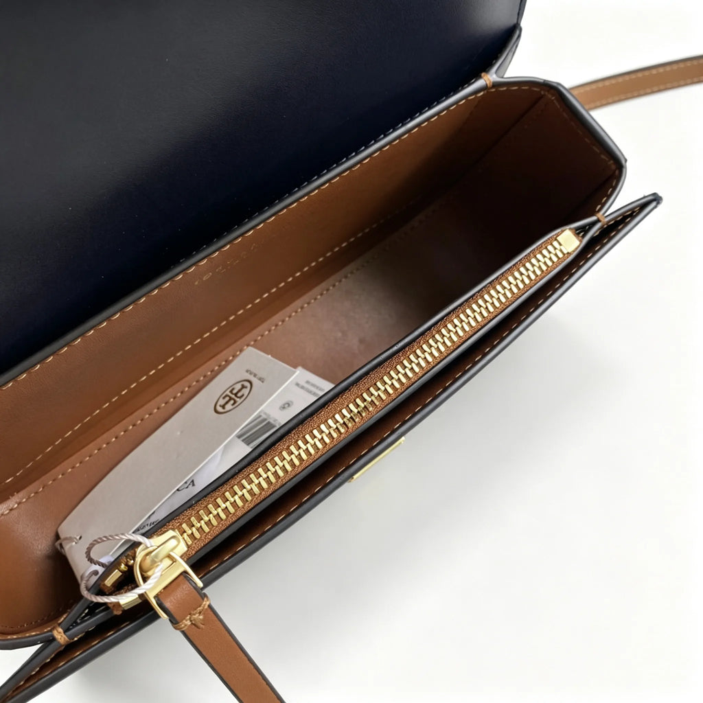 Tory Burch navy and beige Monogram canvas with an adjustable leather shoulder strap convertible into a crossbody or shoulder bag women's style
